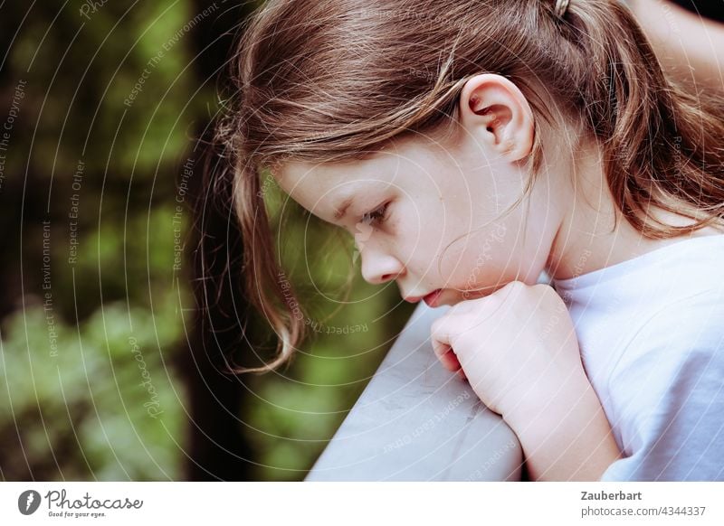 Girl in profile looks down thoughtfully and rests her head on her hand Child Looking Meditative Hand Infancy Human being pretty Cute portrait tranquillity