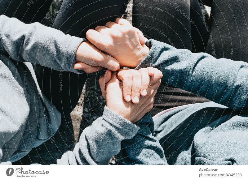 Close up of two old hands grabbing a young hand on cinematic tones affectionate assistance bodycare community friendship giving grandmother grandparent guidance