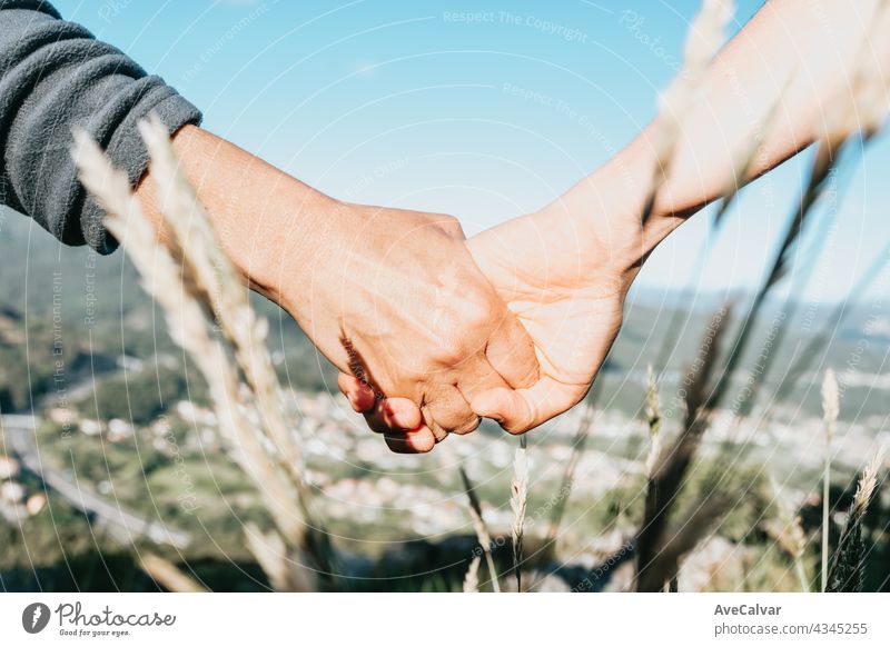 Close up of two old hands grabbing a young hand on cinematic tones affectionate assistance bodycare community friendship giving grandmother grandparent guidance