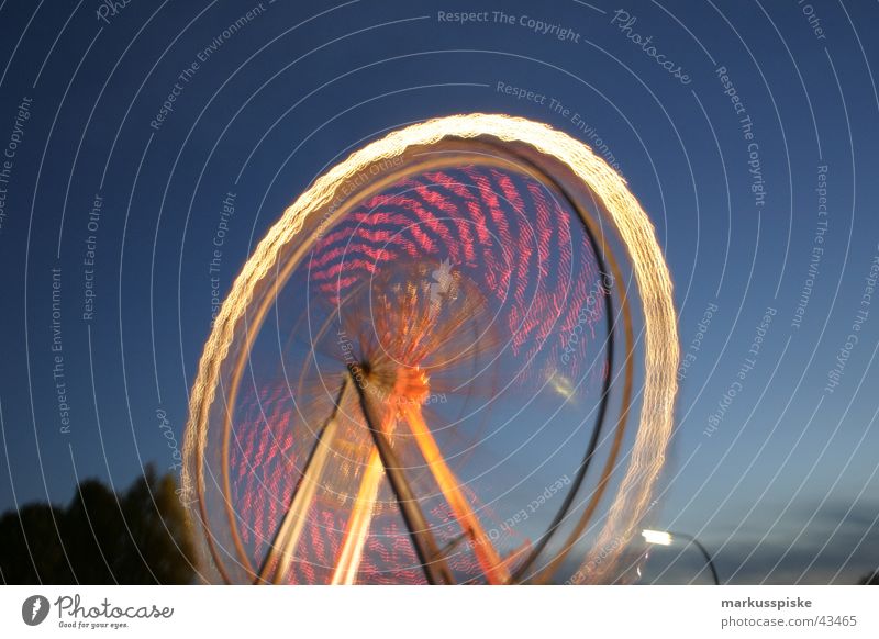 the big wheel Ferris wheel Fairs & Carnivals Night Light Long exposure Multicoloured Twilight Speed Rotate Leisure and hobbies fair Sky Blue Colour