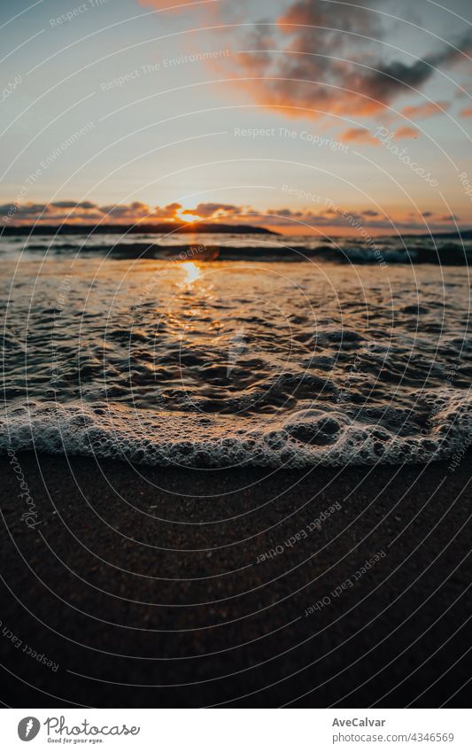 Super close up of some tides with bubbles in the beach during a super colorful sunshine, summer concept, copy space, background wave ocean tropical surf wet