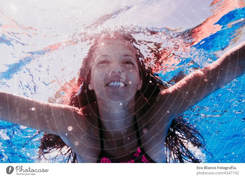 happy caucasian woman diving in swimming pool. underwater view. Summer time and vacation concept fun summer love blue water sunny day outdoors relax beautiful