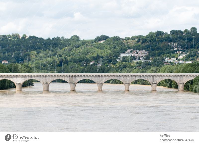 an arch bridge over a river at high water Bridge bridge arch Bridge construction Bridge pier River Flood Traffic infrastructure Architecture brown water