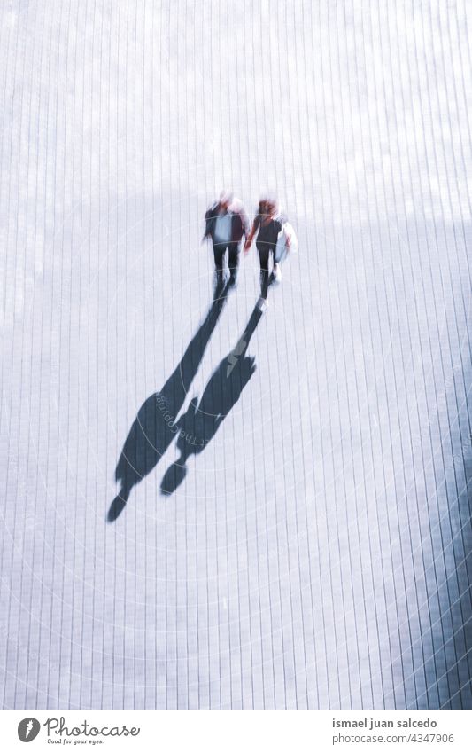 blurred couple walking on the street  visiting Bilbao city, Spain Couple person people pedestrian defocused motion blur motion shadow silhouette outdoors