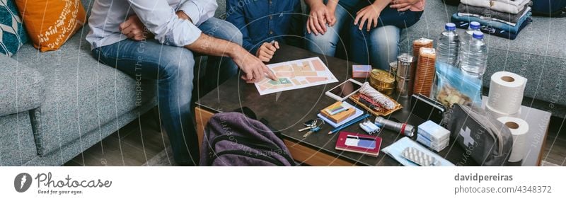 Father explaining to his family the emergency assembly point father map backpack prevention disaster evacuation banner web header panorama panoramic safety