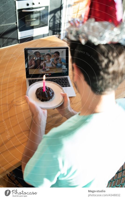 Man celebrating birthday online from home. man laptop celebration communication internet social distancing connection celebrate video call people coronavirus