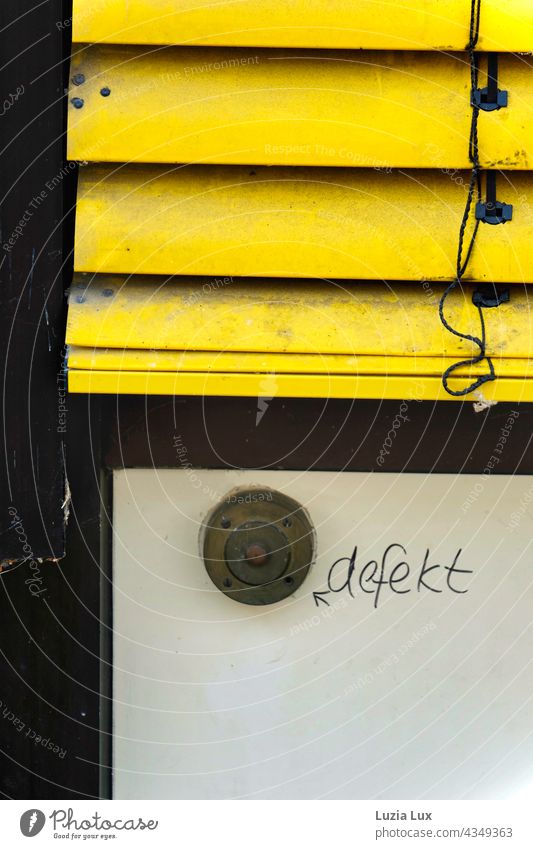 An old bell button, defective Bell ring broken Lettering Clue Old Broken Detail Facade Exterior shot Close-up Trashy Transience Yellow Roller blind