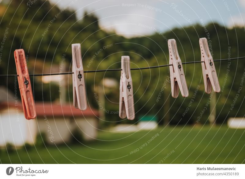 pegs for clothes hanging outdoors wash clean nature clothing yellow background blue clip closeup clothesline clothespin color colorful cord dry fresh green hold