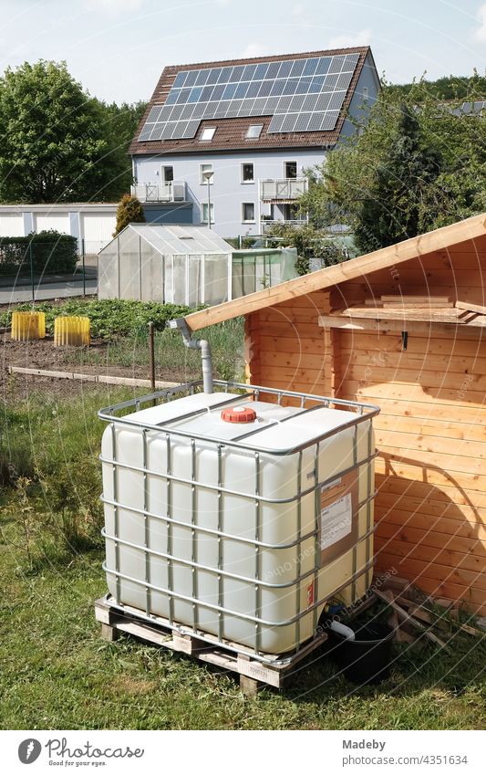 Modern water tank for rainwater in summer sunshine in an allotment garden site in Oerlinghausen near Bielefeld on the Hermannsweg in the Teutoburg Forest in East Westphalia-Lippe