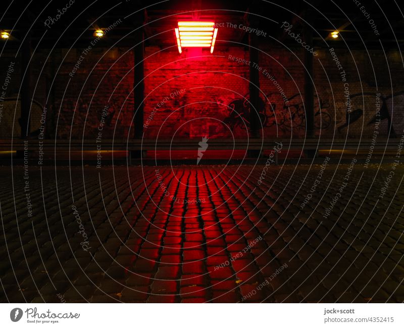 Dark tunnel illuminated by red neon light Tunnel Traffic infrastructure Street Wall (building) Illuminate Lighting installation Cobblestones Column Street art