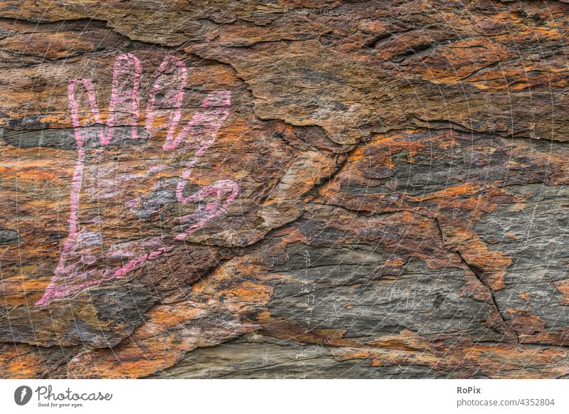 Drawn hand on an oxidized natural stone. masonry Stone urban interstices Graffiti Manmade structures Stone wall Wall (building) street art Subculture Culture