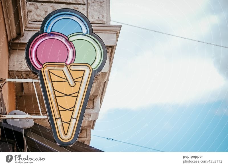 Ice cream cone with three ice cream scoops over an ice cream parlor Ice-cream parlor Summer Colour photo Nutrition Food Candy cute Ice-cream cone Waffle Dessert