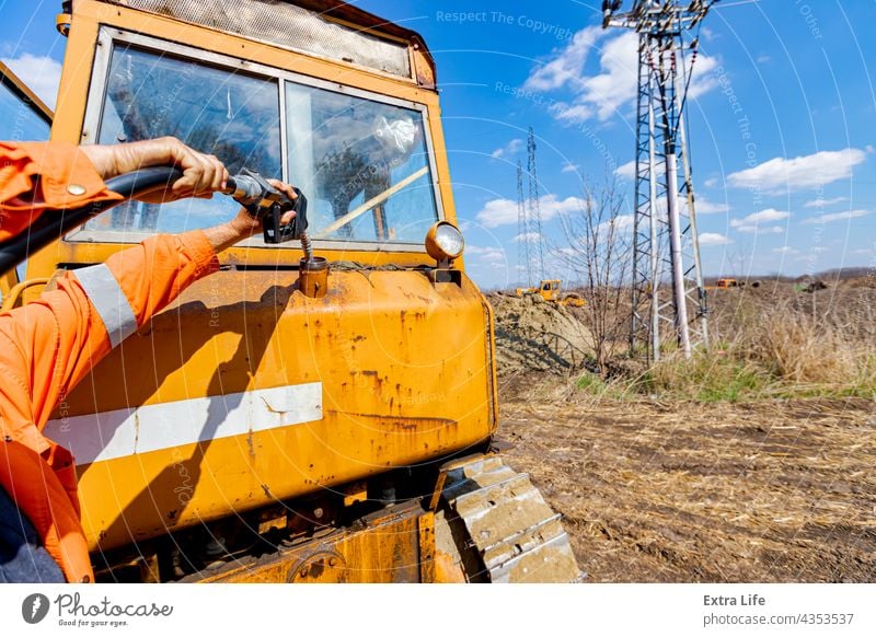 Handle fuel nozzle to refuel, petrol is pouring into the tank of an industrial mechanization Activity Barrel Building Site Bulldozer Civil Engineering