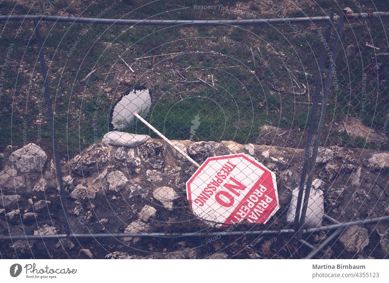 No trespassing sign turned over behind a fence turn over no trespassing sign keep restricted background entry forbidden area warning property security access