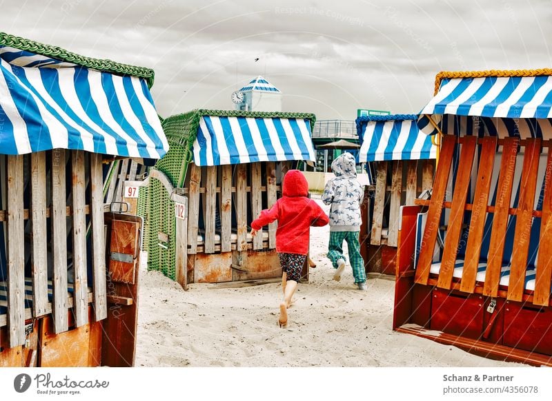 Children running between beach chairs Beach Sand vacation lido Infancy children Bathing beach Summer Ocean Vacation & Travel Sun Swimming & Bathing Relaxation