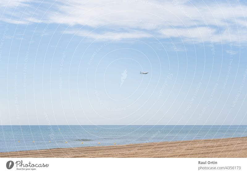 Airplane landing above beautiful beach and sea background airplane transport holidays transportation travel coast ocean sky jet airline vacation aircraft flight