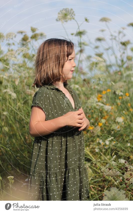 Girl in green polka dot dress stands in summer flower meadow flowers Flower meadow Dress dot pattern Chic Collar Summer Summery Infancy Child Kindergarten