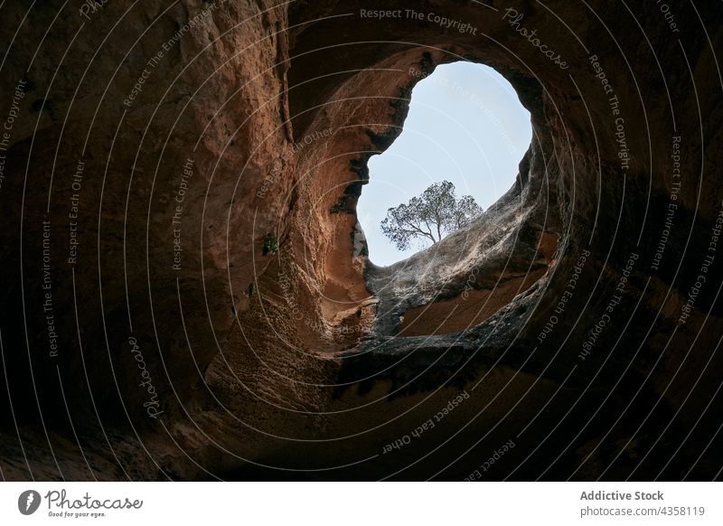 Cave in rocky mountain against cloudy sky cave hole nature formation amazing scenery majestic mount arabi murcia spain scenic stone geology landscape