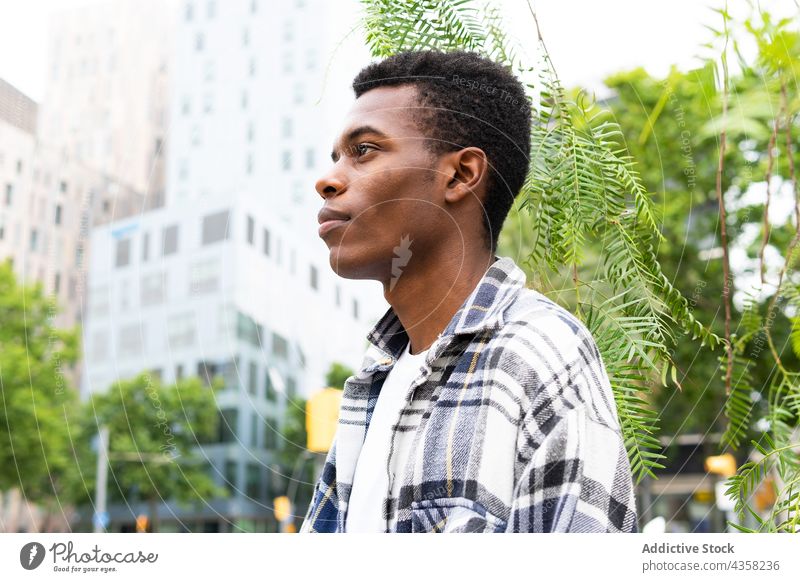 Serious black man standing on the street city urban male modern style trendy ethnic african american relax chill rest convenient contemporary handsome