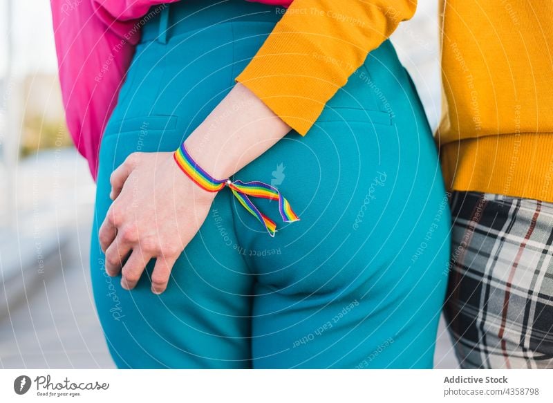 Unrecognizable multiethnic couple of lesbian women walking in city holding hands lgbt homosexual stroll bridge female multiracial diverse black african american