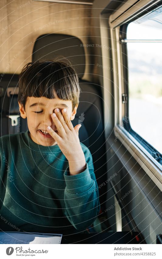 Little boy sitting inside a motorhome child person travel vacation indoors males childhood day motor home journey kid one person relaxation road trip adventure