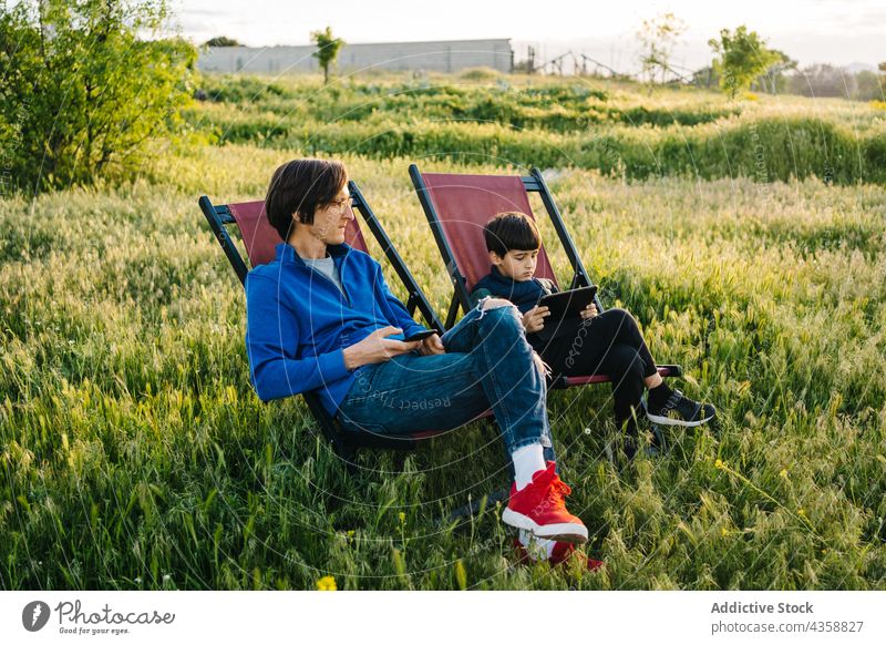 Father and son relaxing in folding hammocks child father family boy people lifestyle outdoors day parent happiness joy kid playing recreation togetherness love