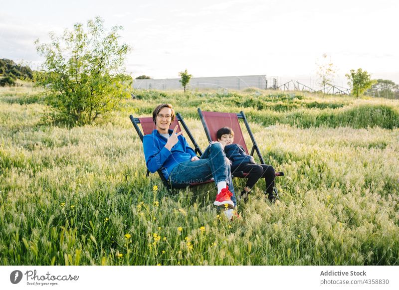 Father and son relaxing in folding hammocks child father family boy people lifestyle outdoors day parent happiness joy kid playing recreation togetherness love