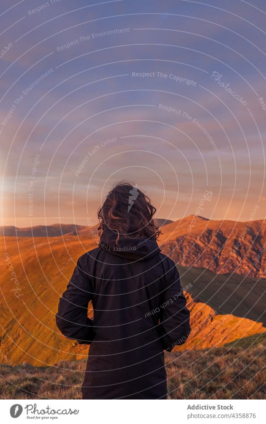 Unrecognizable traveler admiring view of mountains at sunset viewpoint admire trekking observe highland hiker adventure wales united kingdom uk great britain