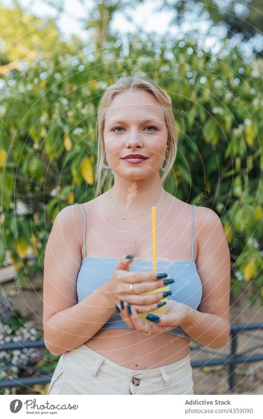 Woman drinking refreshing summer cocktail in park woman lemonade refreshment cold straw beverage female cool weekend tasty enjoy thirst chill delicious sweet