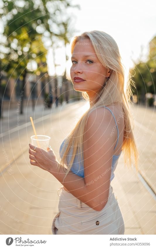 Woman with cold summer cocktail in city woman lemonade refreshment drink street female enjoy plastic cup beverage young takeaway to go cool sweet stand urban