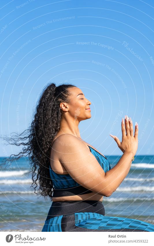 Portrait young female relaxing practicing yoga with namaste on beach woman concentration inspiration copy space relaxation person hands fitness sport adult