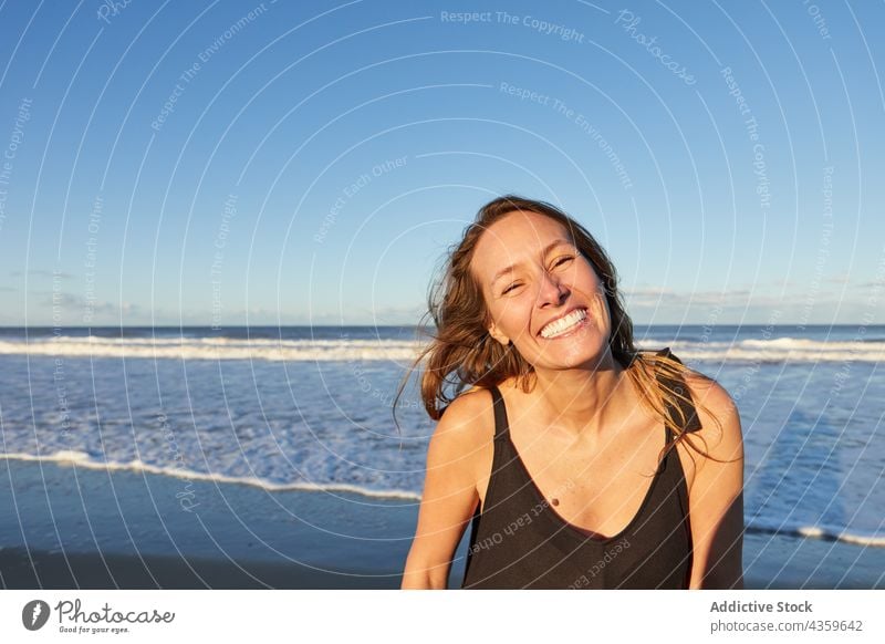 Cheerful woman in dress on beach near sea summer sand seashore vacation smile female happy holiday enjoy travel carefree relax water coast seaside ocean