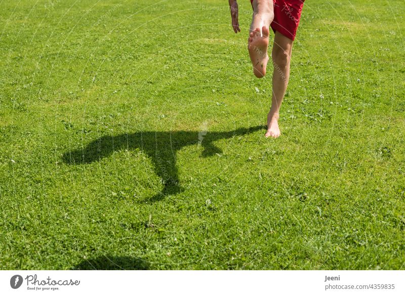 Football with shadow play Foot ball Playing Soccer player Barefoot Sports Ball sports Leisure and hobbies Shadow play Sportiness Movement Child Infancy youthful