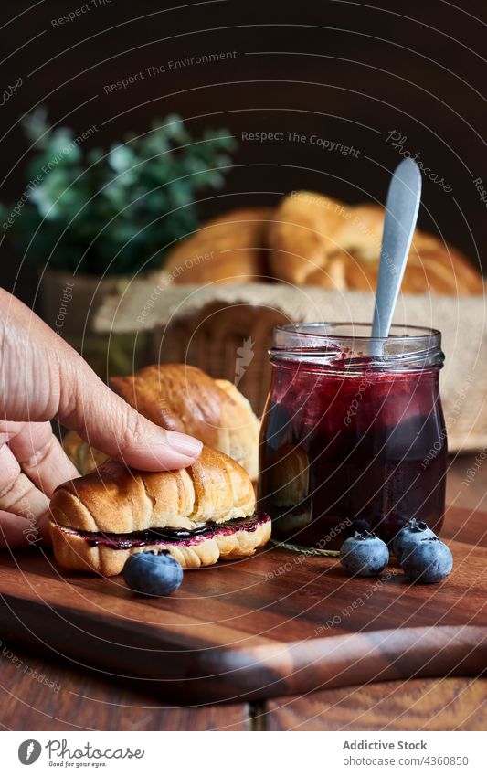 Croissants with blueberry jam on a wooden table croissant breakfast food sweet dining fit energy rustic still fruits dessert spoon blueberries pot blur