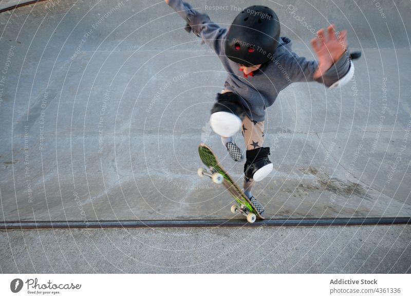 Teenage skater showing trick on skateboard in skate park teenage stunt ride jump boy ramp extreme activity energy hobby active skill sport practice freedom move