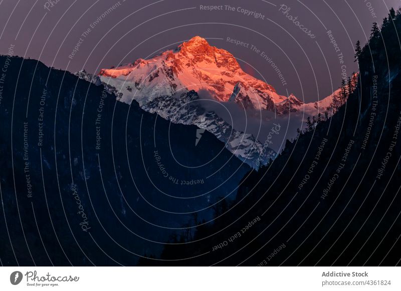 Snowy mountains lit by sunset light in evening snow highland sunlit landscape winter twilight scenery sundown himalayas nepal rock rocky peak scenic sunlight