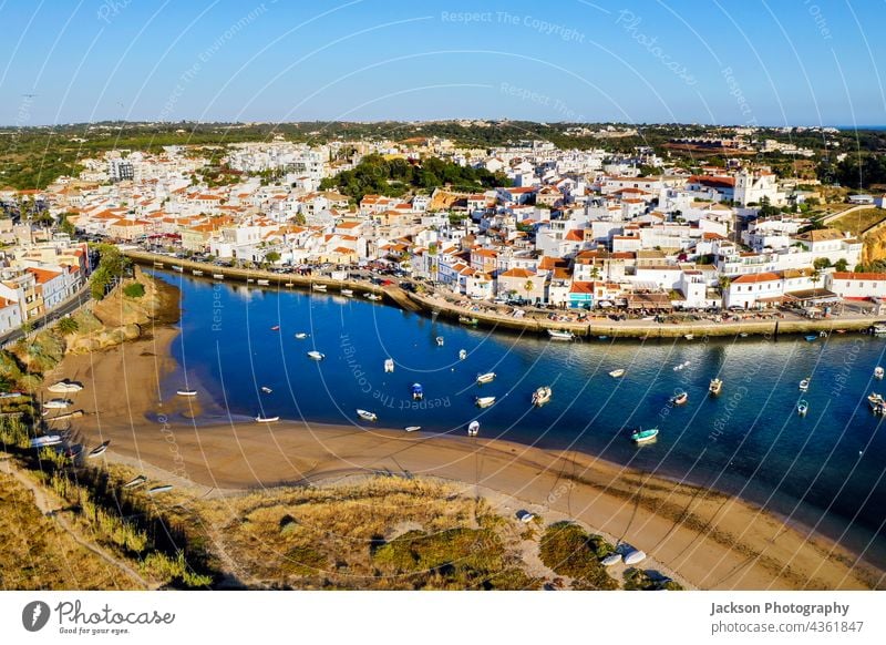 Aerial cityscape of Ferragudo by Arade River, Algarve, Portugal ferragudo portugal algarve aerial river arade ocean architecture above top coastline waterfront