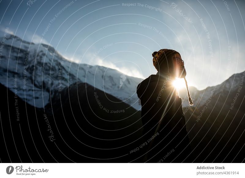 Pensive traveling man standing in mountains in winter traveler highland snow explore adventure male himalayas nepal vacation scenic ridge idyllic hiker enjoy