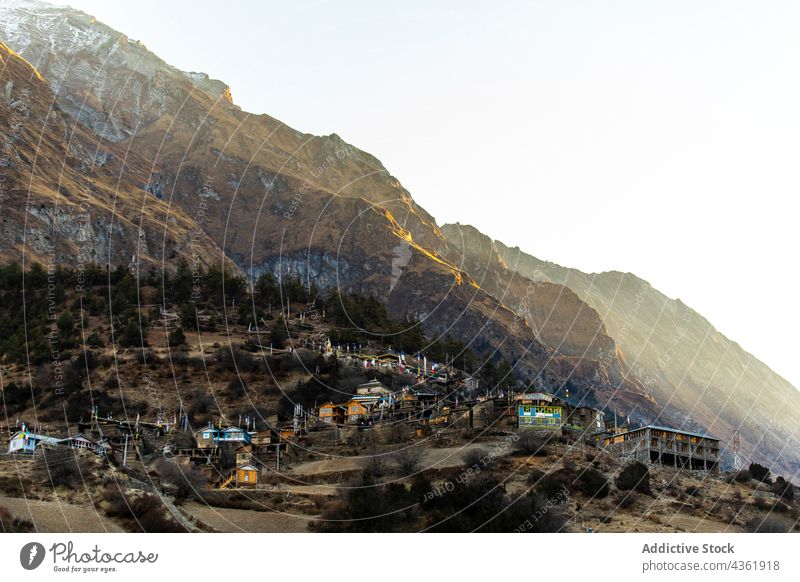 Small village located in mountainous terrain settlement highland morning sunrise slope residential rocky landscape himalayas nepal dwell cottage range sunlight