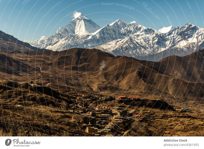 Small settlement located in mountainous valley on sunny day village range building landscape house highland scenery himalayas nepal annapurna ridge picturesque