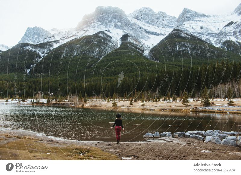 Lonely traveler standing near mountain lake woman nature landscape alone journey environment wanderlust explore female tourism banff national park quarry lake