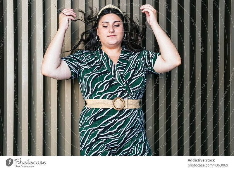 Young curvy woman in stylish dress outfit style fashion ornament geometry plus size stripe female young model trendy elegant modern feminine apparel garment