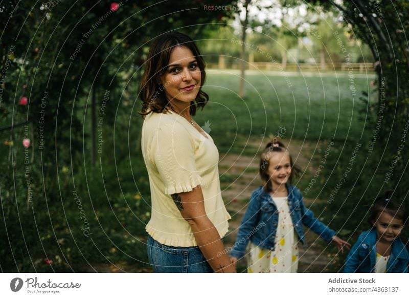 Mother with little siblings walking in park mother kid together love happy daughter summer holding hands similar cute child mom relationship children sister