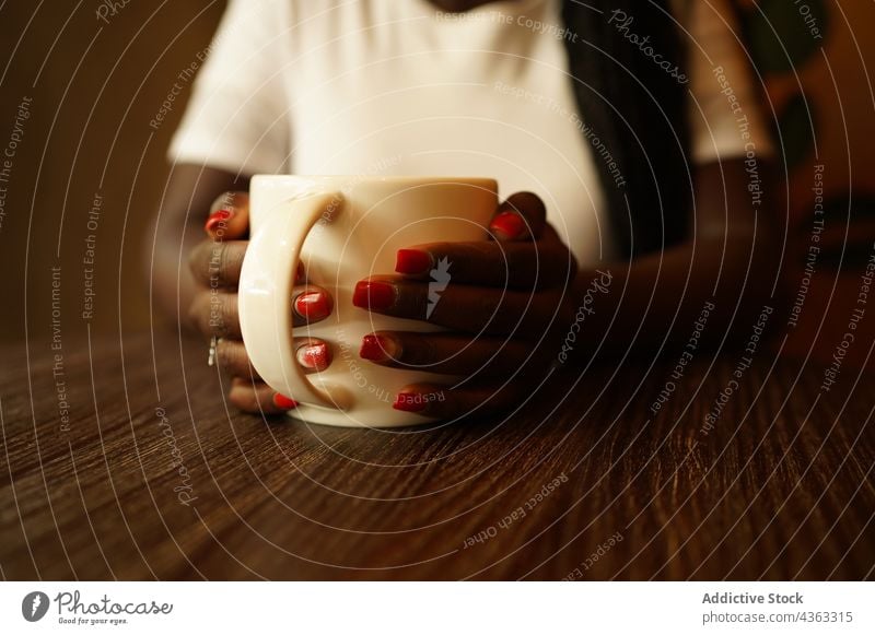 Anonymous African American woman with cup of coffee in cafe drink weekend enjoy beverage female ethnic black african american mug braid tasty delicious relax