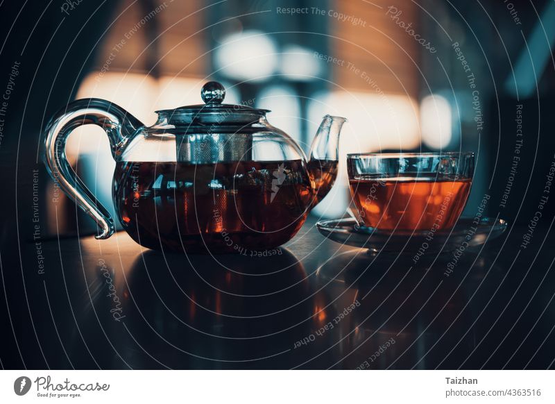 berry   tea in a glass teapot in a cafe. close up summer table health drink honey leaf lemon mint red background breakfast food fruit composition medical