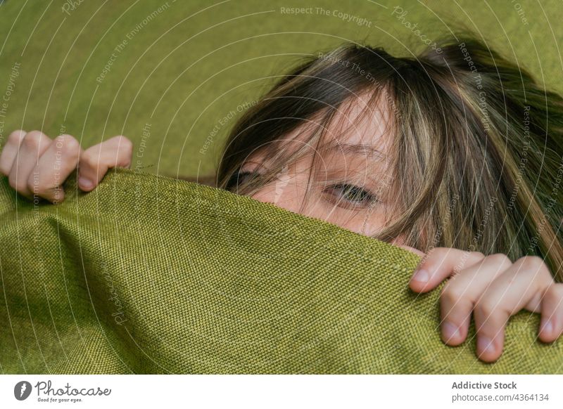 Young woman with green eyes looking at camera color human face gaze stare beauty portrait cover face hide cloth female fair hair long hair young appearance