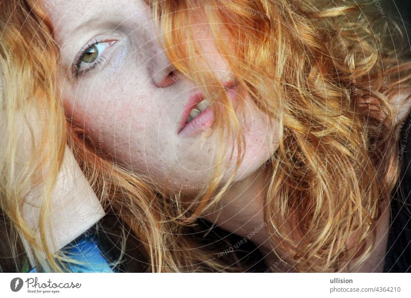 Beautiful sensual portrait in closeup of a thoughtful young redhead wistful Woman Curly Hair Redhead Freckles Auburn Portrait Looking At Camera Girl Women