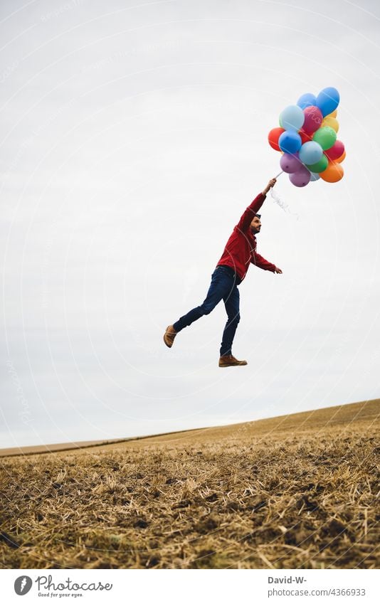 take off and fly - man holding on to balloons Flying Balloon Sky Dream Hover fun Tall Freedom dream Desire Man Ease Go up variegated