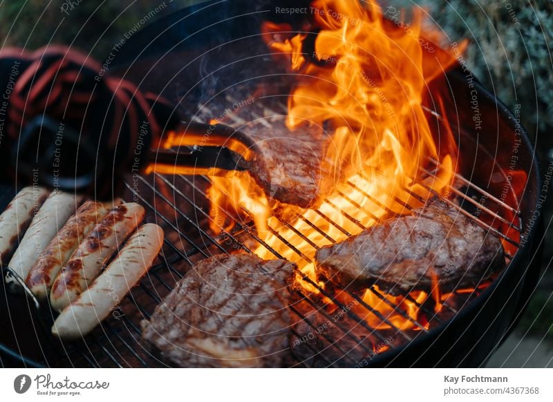 man turning steak on barbeque grill barbecue barbecue - meal barbecue grill bbq beef coal cuisine culinary delicious flames food and drink glowing gourmet