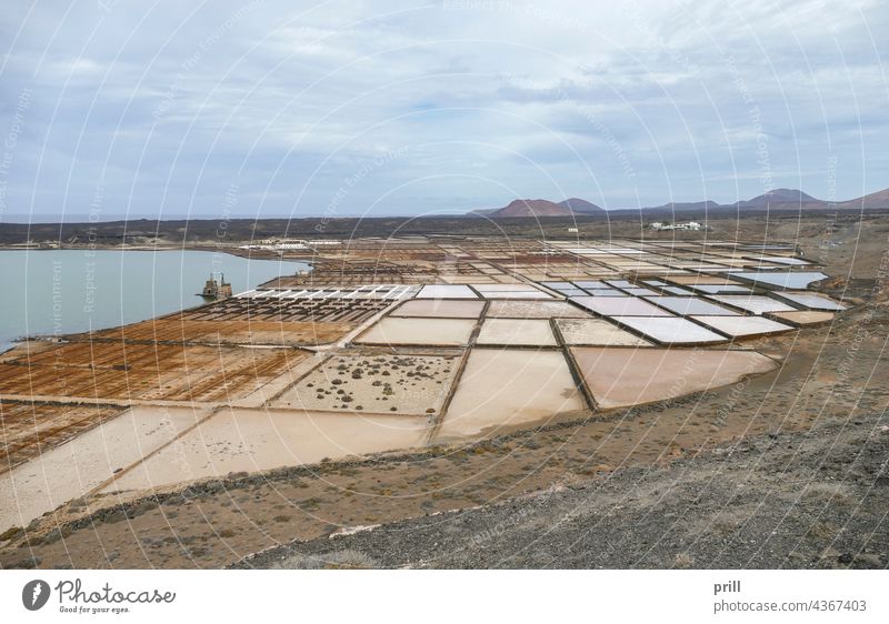 Salinas de Janubio lanzarote canary islands spain salt flat lagoon coast sea production salt production saline field landscape mountain segmented